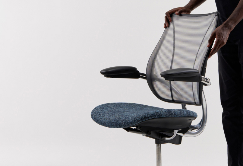 Person with their hands on Liberty chair frame